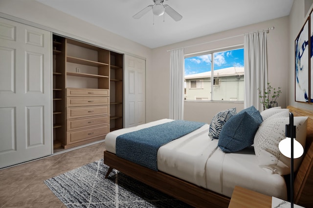 bedroom featuring tile patterned floors, a closet, and ceiling fan