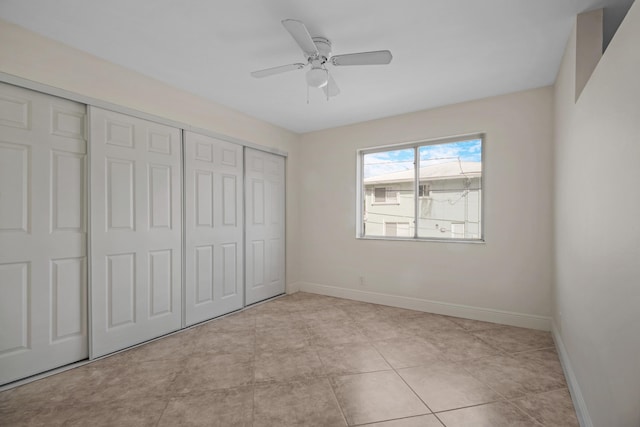 unfurnished bedroom featuring light tile patterned floors, a closet, and ceiling fan