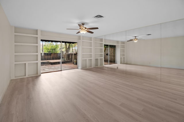 unfurnished living room with ceiling fan, built in features, and light wood-type flooring