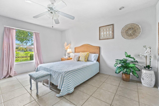 tiled bedroom featuring ceiling fan