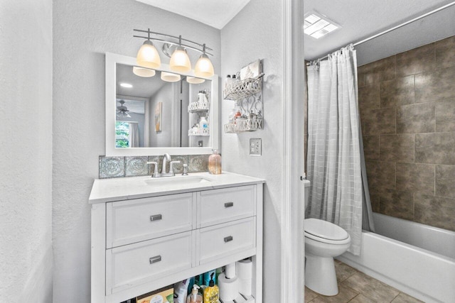 full bathroom with vanity, shower / bath combination with curtain, tile patterned floors, and toilet