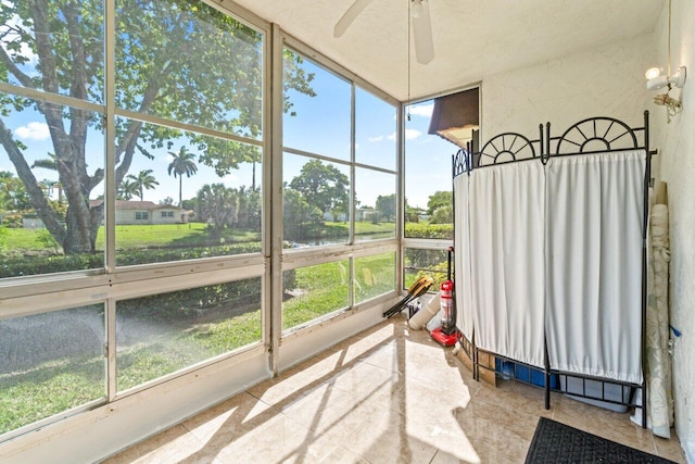 sunroom featuring ceiling fan