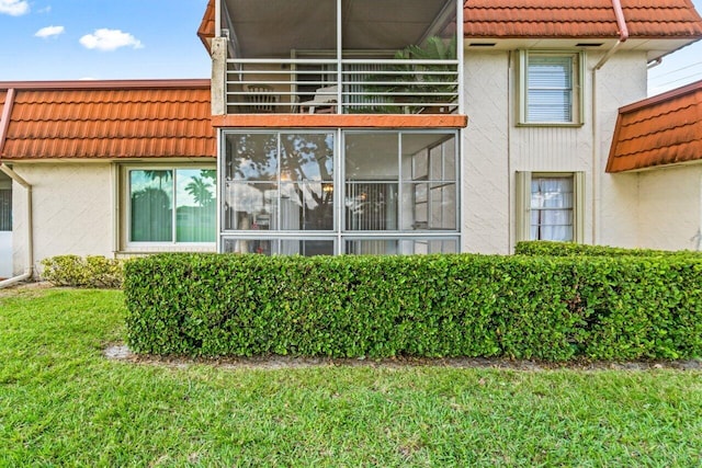 view of side of property with a lawn