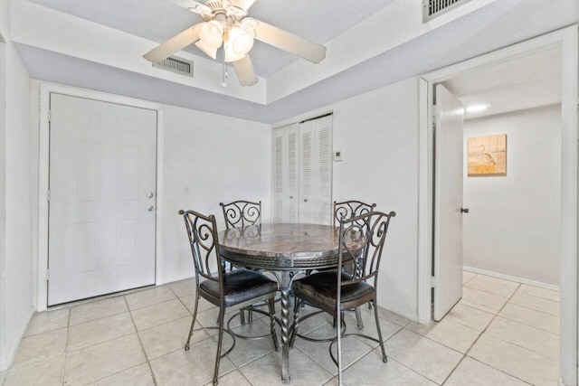 tiled dining area featuring ceiling fan