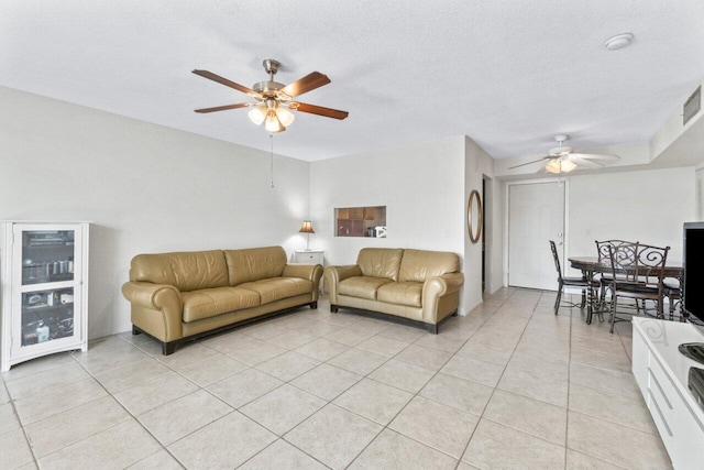 living room featuring wine cooler, ceiling fan, a textured ceiling, and light tile patterned floors