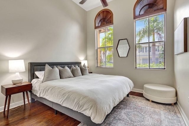 bedroom with wood-type flooring and vaulted ceiling