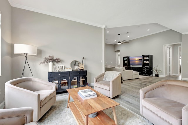 living room with ornamental molding, ceiling fan, and light hardwood / wood-style flooring