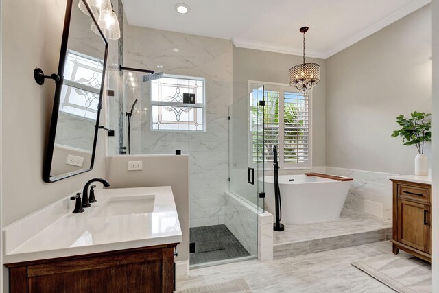 bathroom with vanity, an inviting chandelier, crown molding, and plus walk in shower