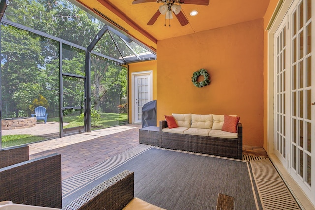 sunroom / solarium featuring ceiling fan