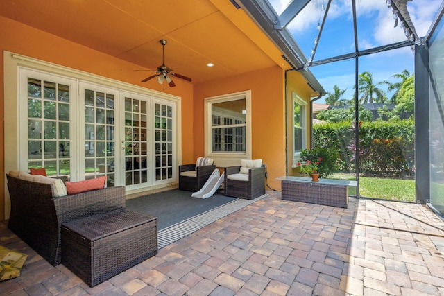 view of patio / terrace featuring ceiling fan, outdoor lounge area, and glass enclosure