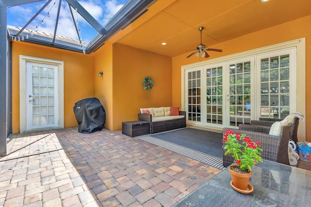 view of patio featuring french doors, ceiling fan, an outdoor hangout area, and area for grilling