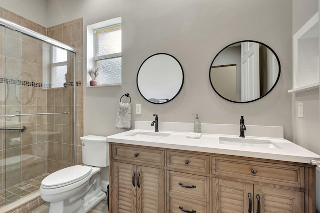 bathroom with walk in shower, vanity, and toilet