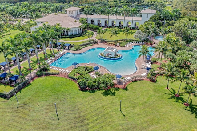 view of pool with a lawn