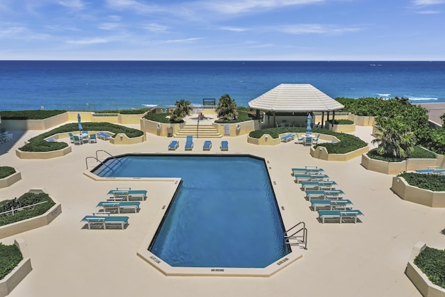 view of pool featuring a gazebo, a patio area, and a water view