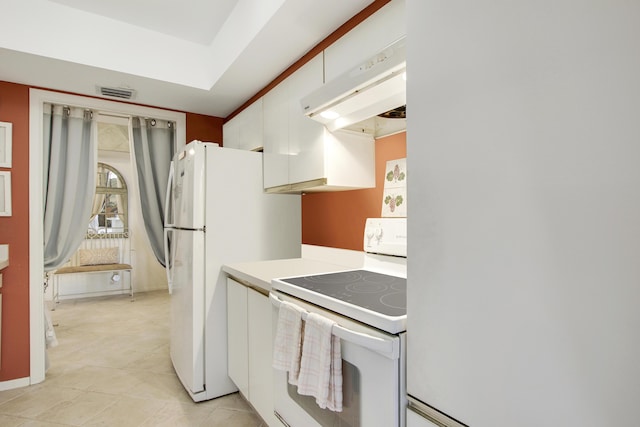 kitchen featuring white cabinetry and white appliances