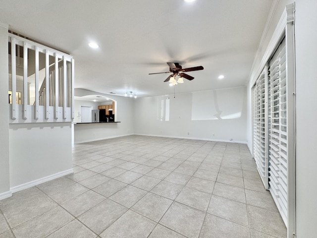 interior space featuring light tile patterned flooring and ceiling fan