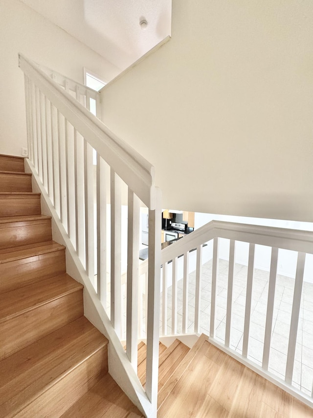 stairway featuring wood-type flooring