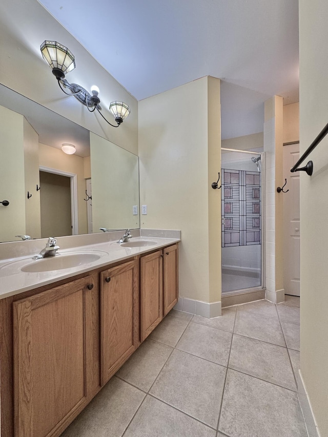 bathroom featuring tile patterned floors, a shower with door, and vanity