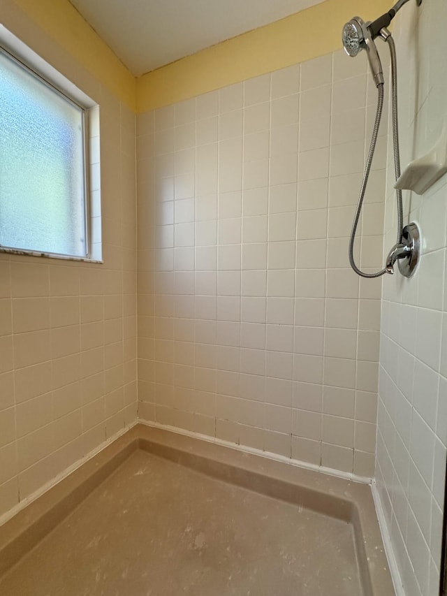 bathroom with a tile shower