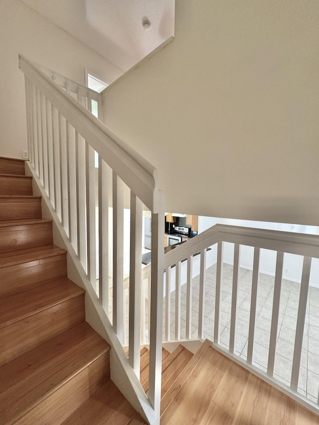 stairs featuring wood-type flooring