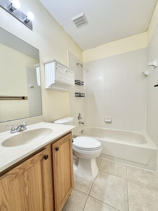 full bathroom featuring tiled shower / bath combo, tile patterned floors, vanity, and toilet