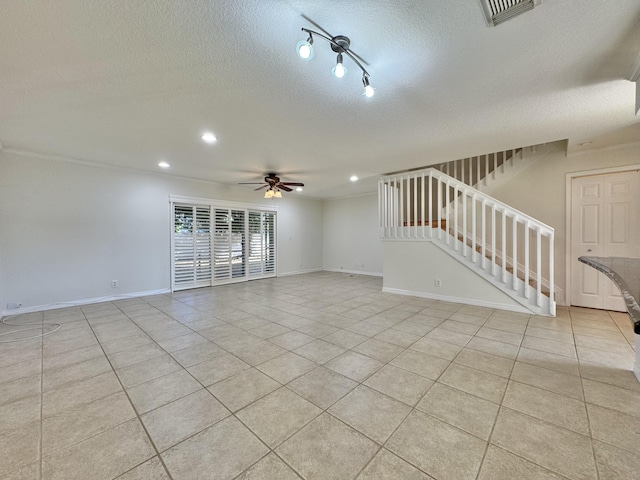 unfurnished living room with light tile patterned floors, a textured ceiling, and ceiling fan