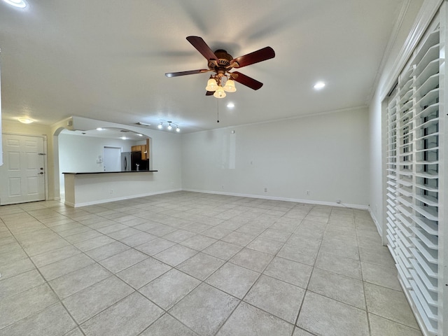 unfurnished living room with ceiling fan and light tile patterned floors