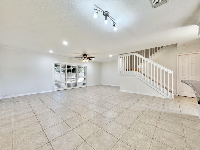 unfurnished living room with light tile patterned floors, ceiling fan, and a textured ceiling