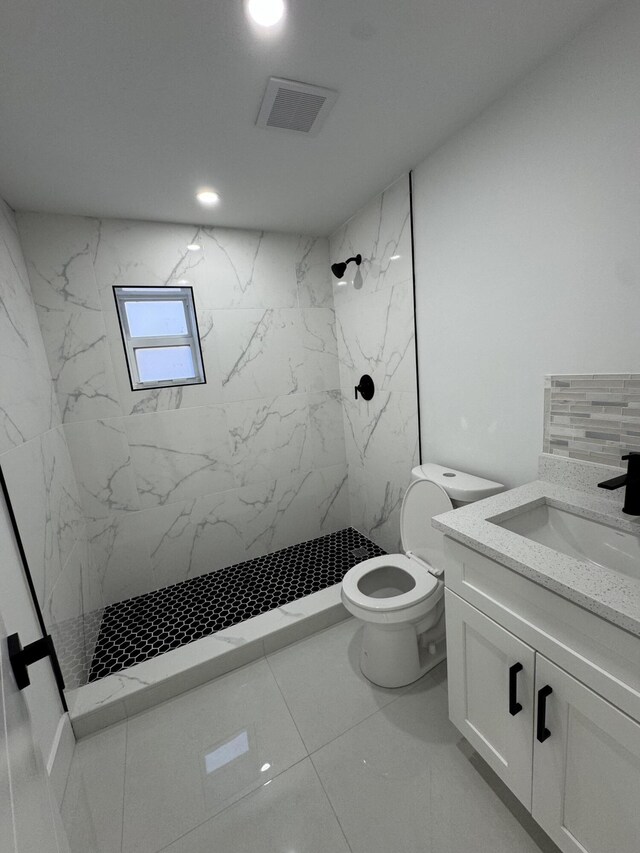 kitchen featuring sink, backsplash, stainless steel appliances, light stone counters, and white cabinets