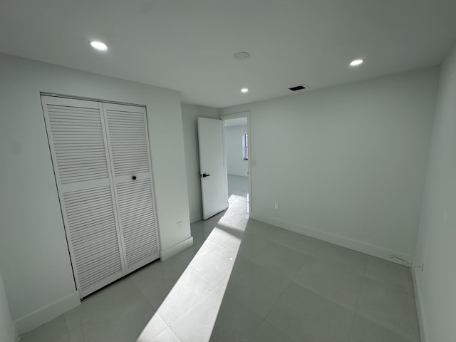 tiled bedroom featuring a closet