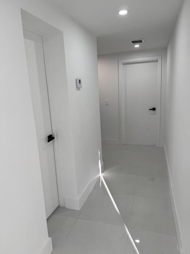 corridor featuring light tile patterned flooring