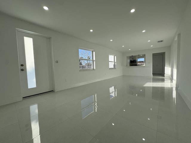 unfurnished living room featuring light tile patterned floors