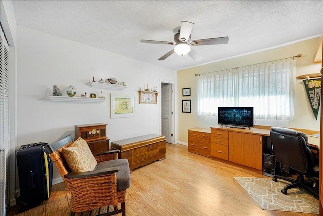 office space featuring ceiling fan, a textured ceiling, and light hardwood / wood-style flooring