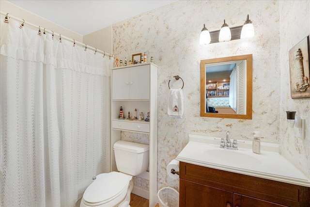 bathroom featuring vanity, toilet, and curtained shower