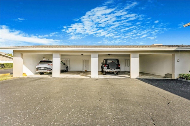 view of vehicle parking with a carport