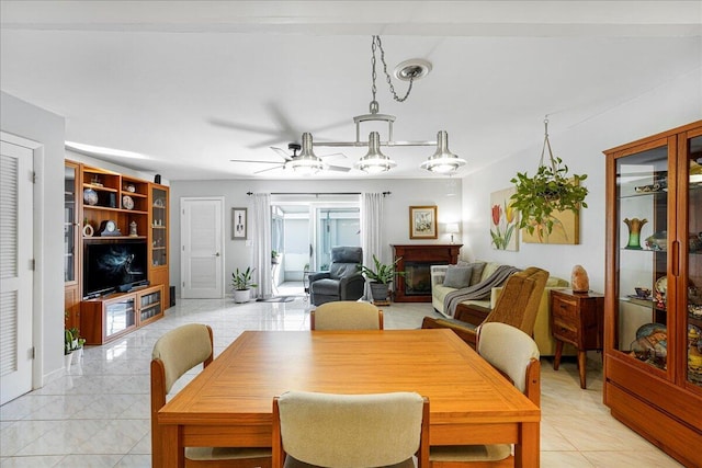 dining area with light tile patterned flooring and ceiling fan