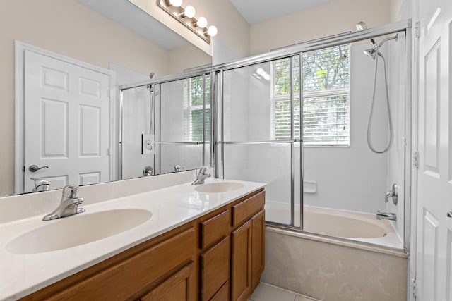 bathroom featuring tile patterned flooring, bath / shower combo with glass door, and vanity