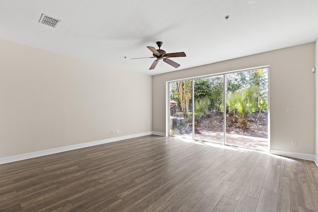 empty room featuring ceiling fan and dark hardwood / wood-style floors