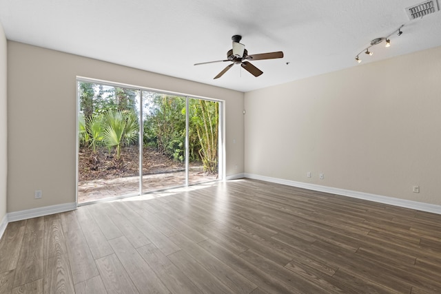 spare room featuring hardwood / wood-style floors and ceiling fan