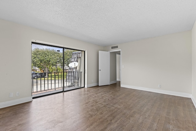 unfurnished room featuring hardwood / wood-style flooring and a textured ceiling