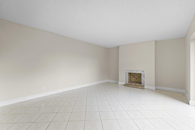 unfurnished living room with a fireplace and a textured ceiling