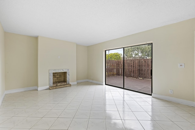 unfurnished living room featuring light tile patterned floors and a textured ceiling