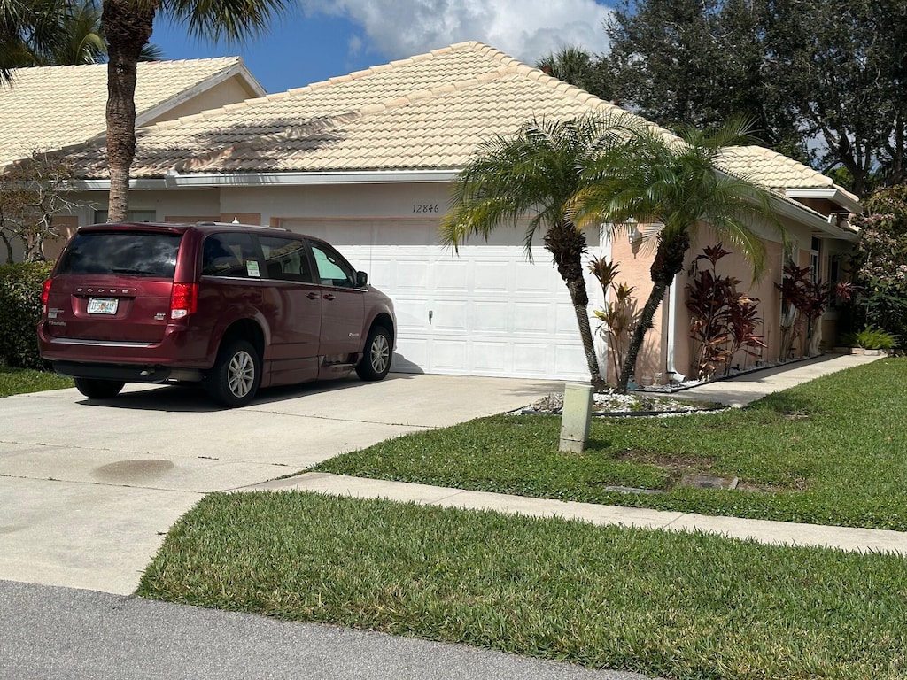 view of side of home featuring a yard and a garage