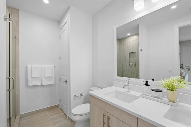 full bath featuring recessed lighting, toilet, a stall shower, and vanity