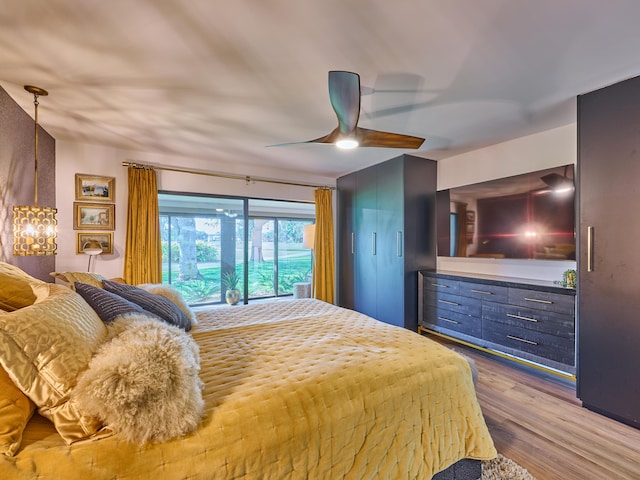 bedroom with hardwood / wood-style flooring, access to exterior, and ceiling fan