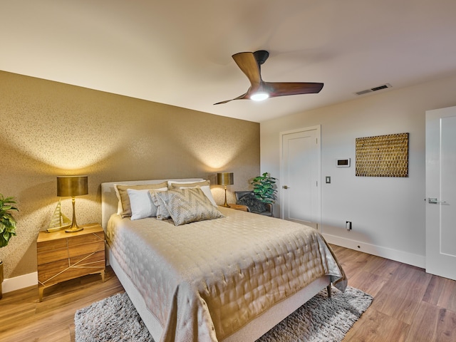 bedroom with wood-type flooring and ceiling fan