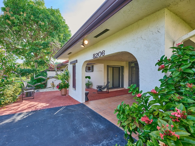 doorway to property featuring a patio