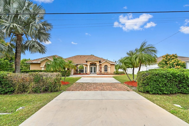 mediterranean / spanish home with a front yard