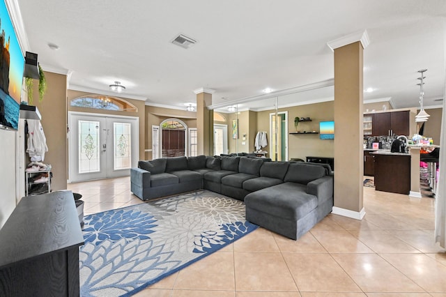 tiled living room featuring french doors and ornamental molding