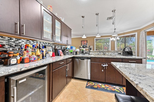 kitchen featuring sink, hanging light fixtures, dark brown cabinetry, stainless steel dishwasher, and beverage cooler